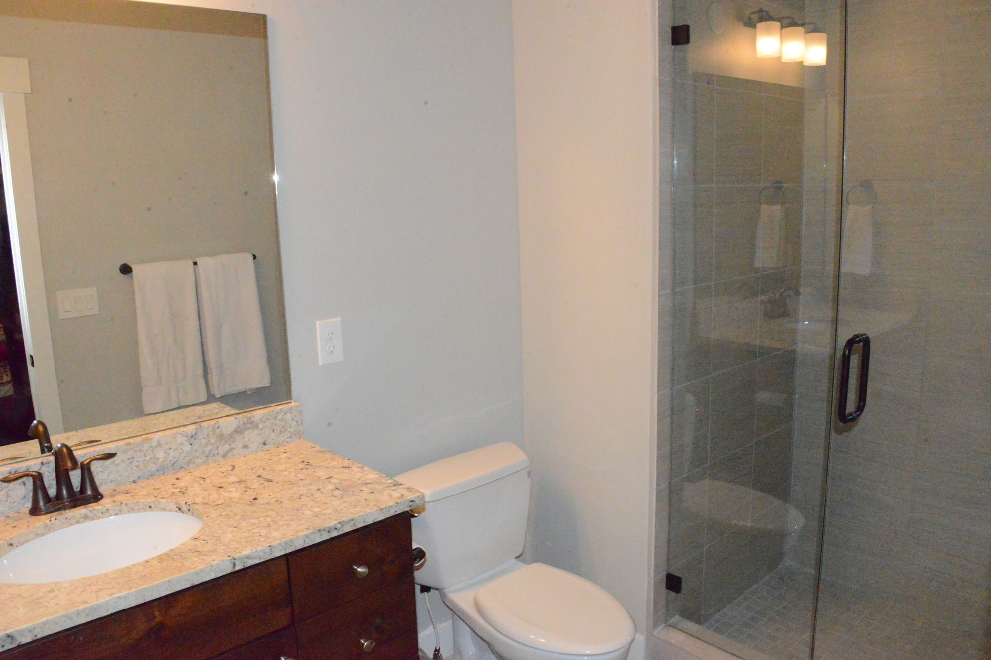Bathroom with granite vanity and glass walk-in shower
