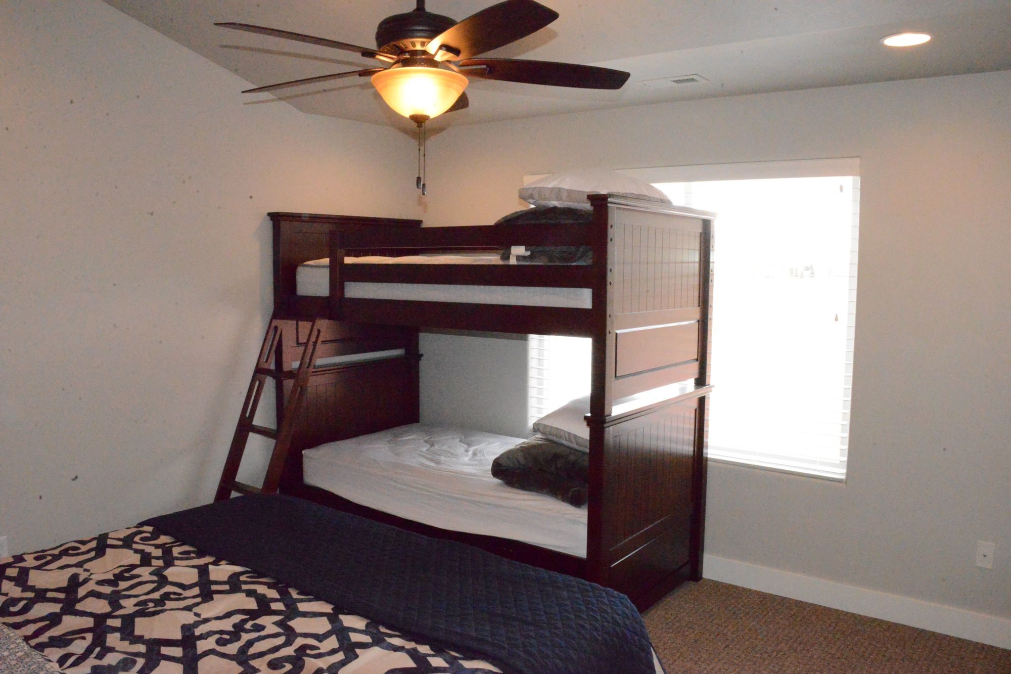 Bedroom with a bunk bed and a bed beside it