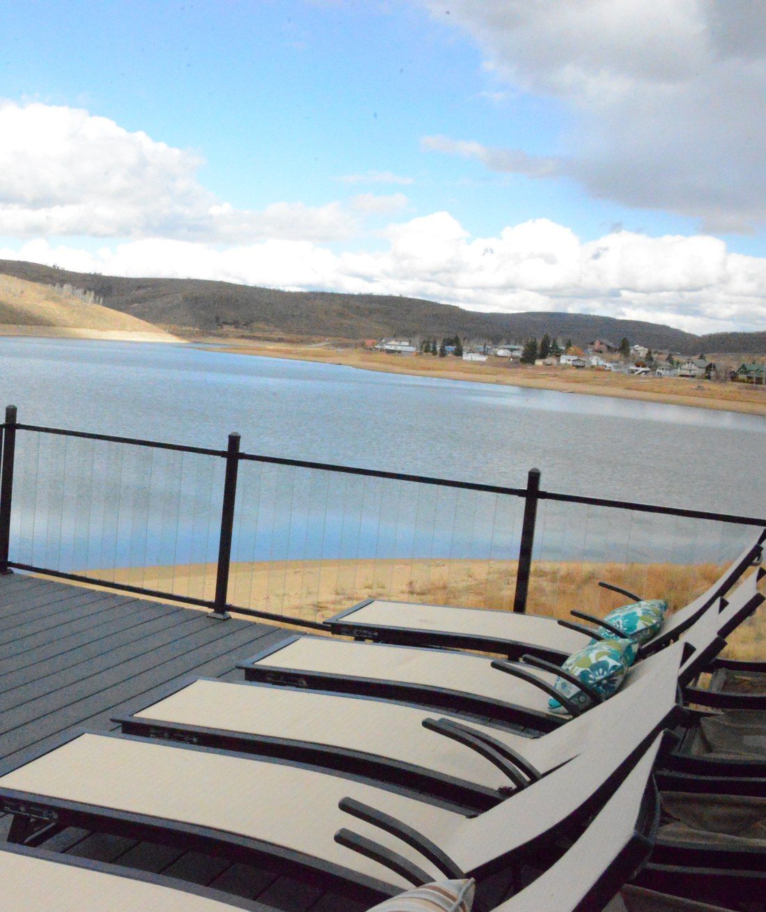 Row of chaise loungers on the upper deck overlooking Scofield Reservoir and the town across the water