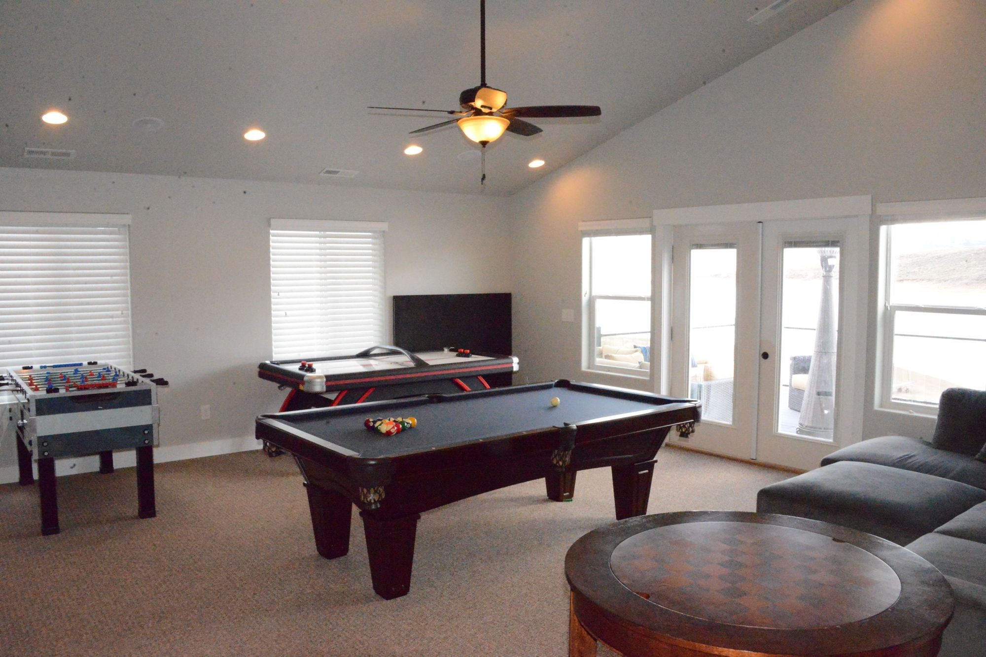 Upstairs game room with French doors out to the balcony lounge chairs