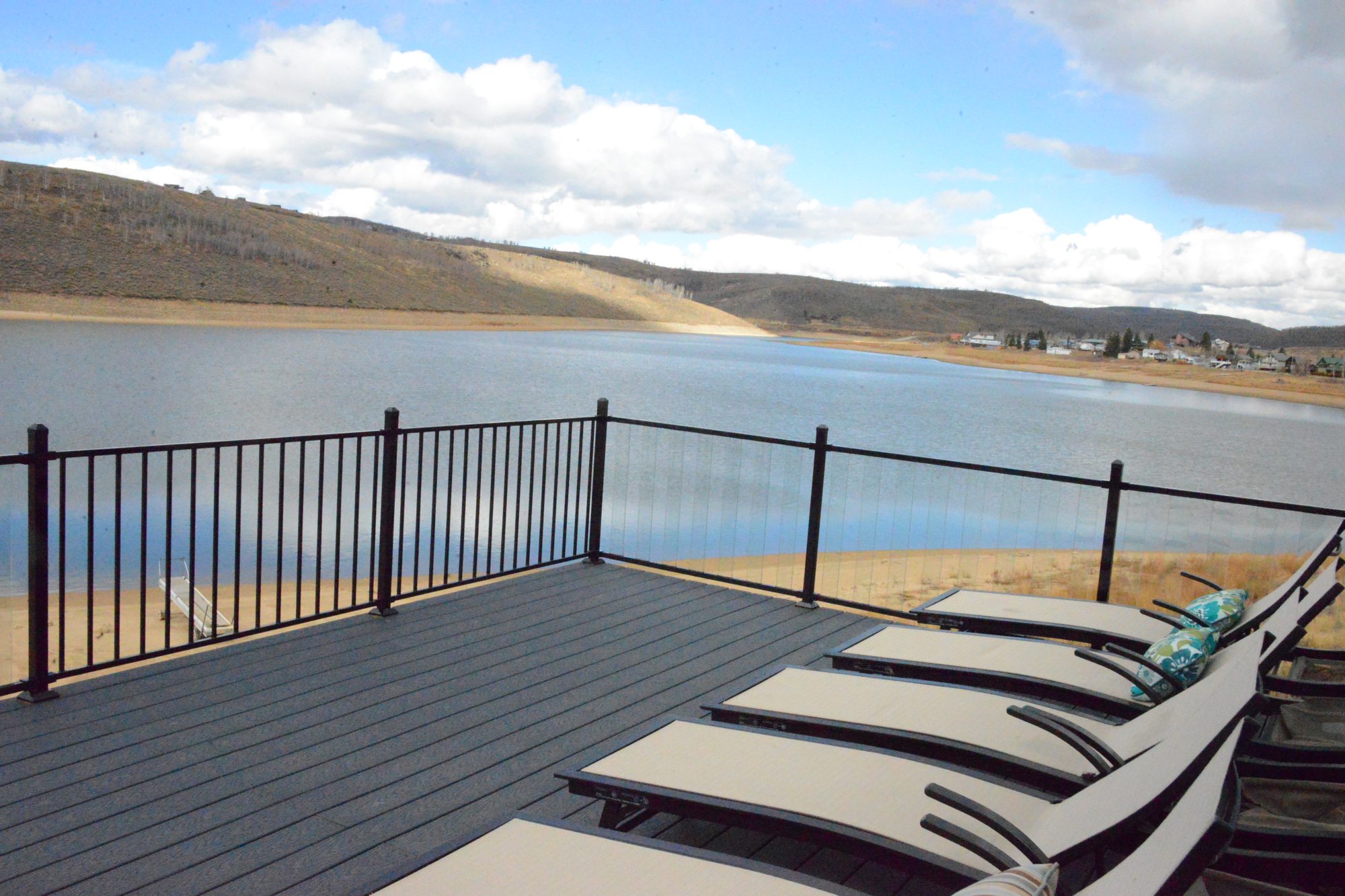Row of chaise loungers on the upper deck overlooking the lake